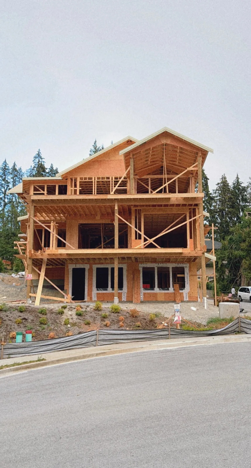 House frame showing rafters and a complex roof structure