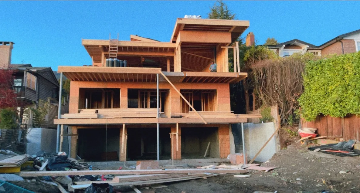 Large wood-framed home on a sloped residential site in BC
